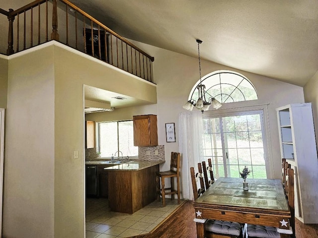 1202 Bowen Ave, Copperas Cove, TX 76522 - dining room featuring vaulted ceiling, a chandelier, and light wood-style flooring