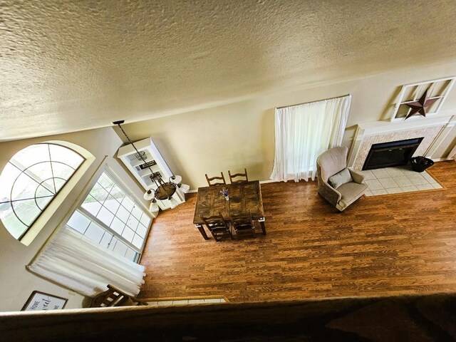 1202 Bowen Ave, Copperas Cove, TX 76522 - living area featuring a textured ceiling, wood finished floors, and a tile fireplace