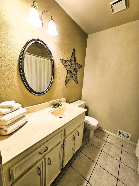 1202 Bowen Ave, Copperas Cove, TX 76522 - bathroom with vanity, tile patterned flooring, and a textured wall