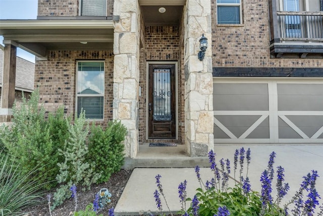 1624 Stone House Dr, New Braunfels, TX 78132 - view of exterior entry with brick siding, a garage, and stone siding