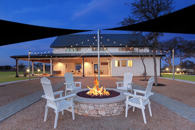 1624 Stone House Dr, New Braunfels, TX 78132 - patio at twilight featuring an outdoor fire pit and a patio
