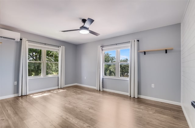 3112 Oak Ridge Dr, Horseshoe Bay, TX 78657 - unfurnished room featuring healthy amount of natural light, a ceiling fan, light wood finished floors, and a wall unit AC
