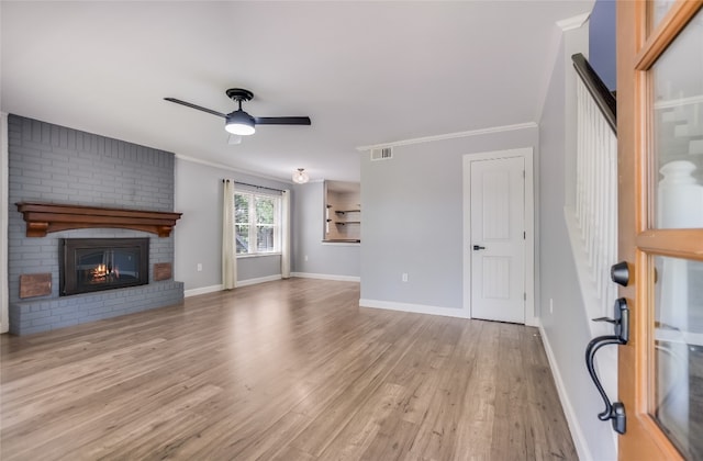 3112 Oak Ridge Dr, Horseshoe Bay, TX 78657 - unfurnished living room with ceiling fan, wood finished floors, crown molding, and a fireplace