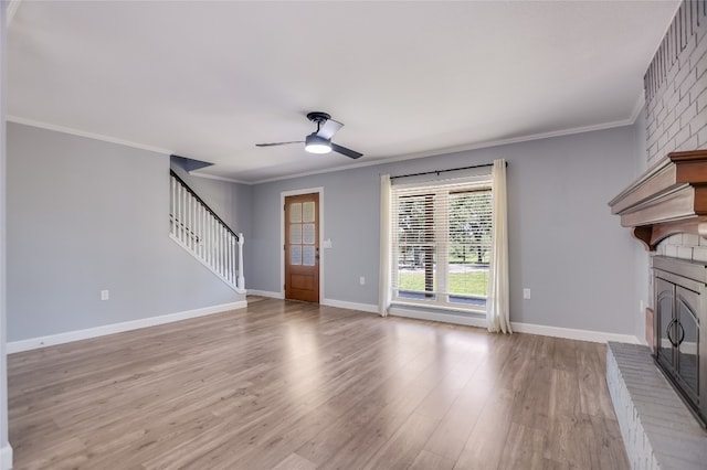 3112 Oak Ridge Dr, Horseshoe Bay, TX 78657 - unfurnished living room with stairway, a ceiling fan, wood finished floors, ornamental molding, and a fireplace