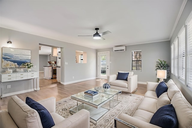 3112 Oak Ridge Dr, Horseshoe Bay, TX 78657 - living room featuring a wall unit AC, light wood-type flooring, ceiling fan, and crown molding