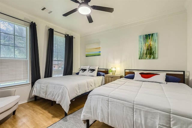 1016 Thackeray Ln, Pflugerville, TX 78660 - bedroom featuring wood finished floors, crown molding, and a ceiling fan