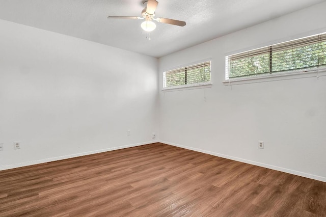 9611 Meadowheath Dr, Austin, TX 78729 - empty room featuring ceiling fan, wood finished floors, and a textured ceiling