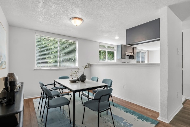 9611 Meadowheath Dr, Austin, TX 78729 - dining space with dark wood-style floors and a textured ceiling