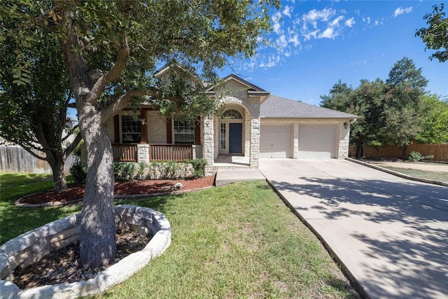 4204 Pasada Ln, Round Rock, TX 78681 - view of front of property with stone siding, a garage, covered porch, and driveway