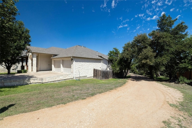 4204 Pasada Ln, Round Rock, TX 78681 - view of home's exterior with an attached garage, driveway, and stone siding