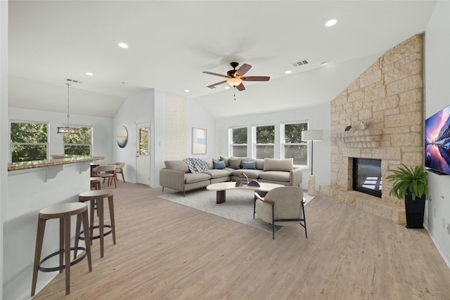 4204 Pasada Ln, Round Rock, TX 78681 - living room featuring lofted ceiling, plenty of natural light, light wood-type flooring, a fireplace, and a ceiling fan