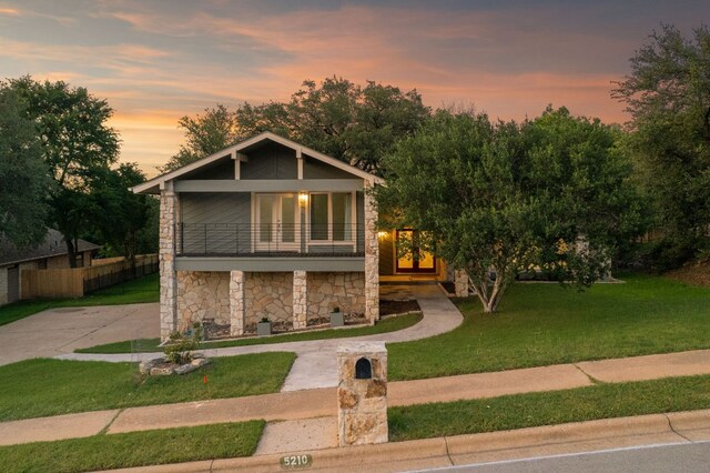 5210 Rain Creek Pkwy, Austin, TX 78759 - view of front of home featuring a balcony, stone siding, and driveway