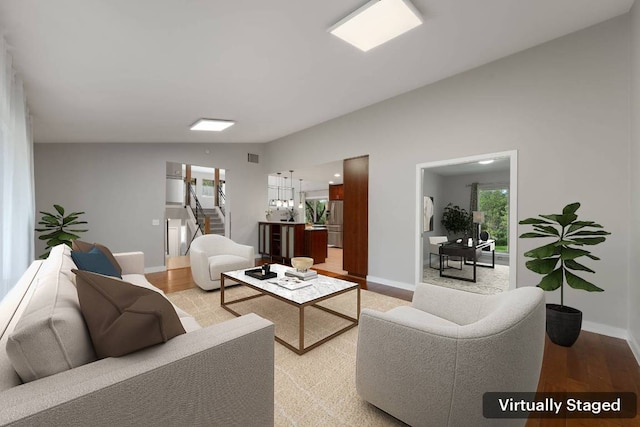 5210 Rain Creek Pkwy, Austin, TX 78759 - living area featuring healthy amount of natural light, lofted ceiling, light wood-style floors, and stairs