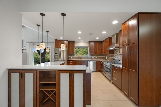 5210 Rain Creek Pkwy, Austin, TX 78759 - kitchen featuring wall chimney range hood, appliances with stainless steel finishes, backsplash, pendant lighting, and light countertops