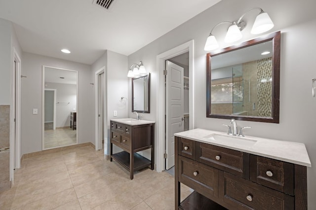 5210 Rain Creek Pkwy, Austin, TX 78759 - full bath featuring two vanities, tile patterned flooring, recessed lighting, and tiled shower