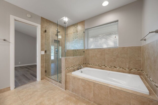 5210 Rain Creek Pkwy, Austin, TX 78759 - bathroom with a garden tub, a shower stall, and tile patterned floors