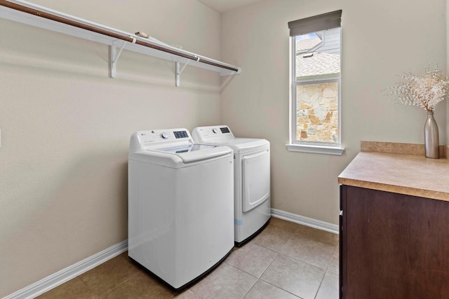 112 Florenz Ln, Georgetown, TX 78628 - laundry area featuring washing machine and dryer and light tile patterned flooring