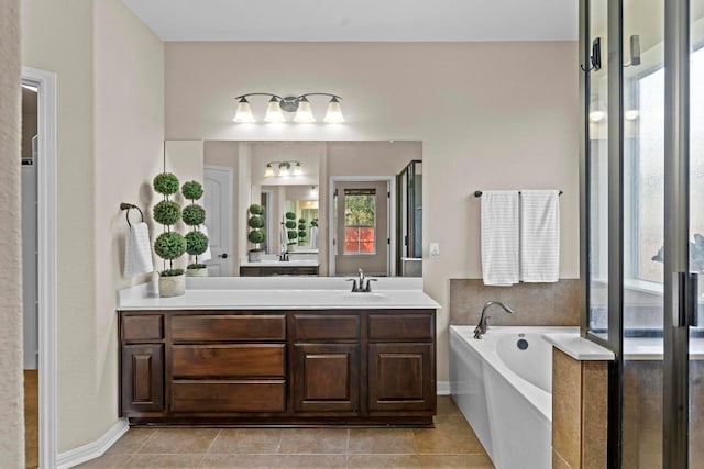 112 Florenz Ln, Georgetown, TX 78628 - bathroom with vanity, a garden tub, and tile patterned flooring