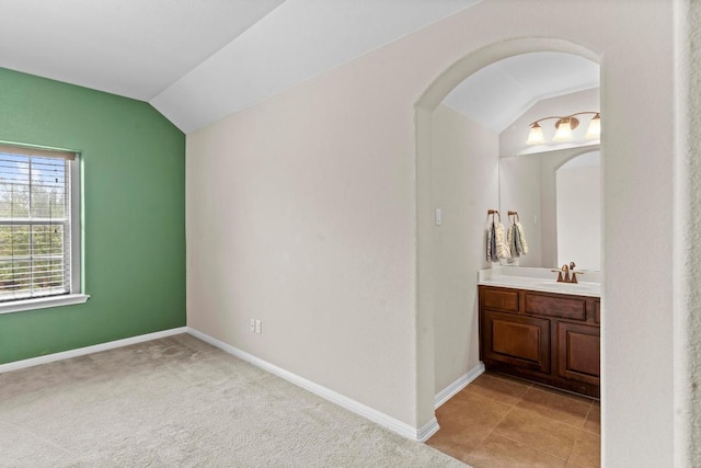 112 Florenz Ln, Georgetown, TX 78628 - unfurnished bedroom with vaulted ceiling, arched walkways, and ensuite bathroom