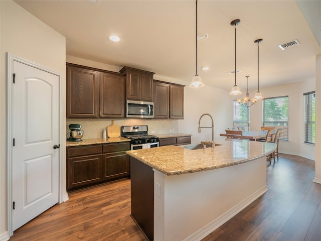 22617 Fountaingrass Ln, Lago Vista, TX 78645 - kitchen featuring stainless steel appliances, dark brown cabinetry, dark wood-style flooring, and recessed lighting