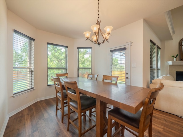 22617 Fountaingrass Ln, Lago Vista, TX 78645 - dining area featuring dark wood-style floors, a chandelier, and a tile fireplace