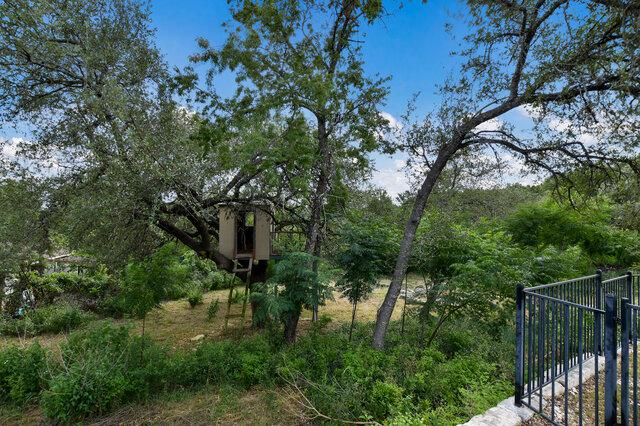 1906 W Moeta Dr, Austin, TX 78734 - exterior view of a gate and a heavily wooded area