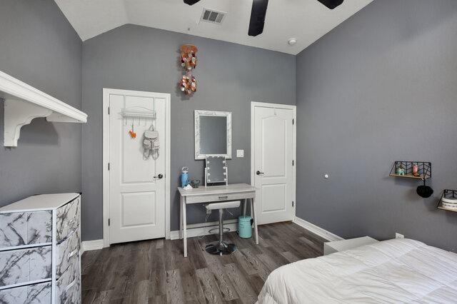 1906 W Moeta Dr, Austin, TX 78734 - bedroom with vaulted ceiling, wood finished floors, and ceiling fan