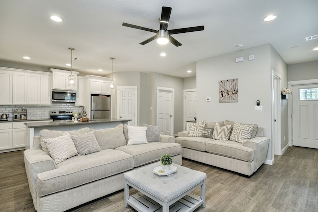 125 Hawea Ln, Bastrop, TX 78602 - living room with dark wood-type flooring, a ceiling fan, and recessed lighting
