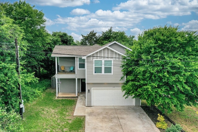 125 Hawea Ln, Bastrop, TX 78602 - view of front of property featuring a balcony, concrete driveway, an attached garage, and a front lawn