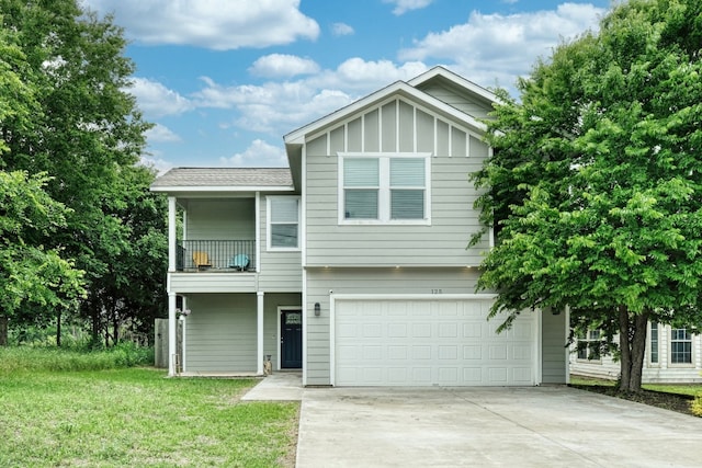 125 Hawea Ln, Bastrop, TX 78602 - view of front of house with a garage, a balcony, concrete driveway, a front lawn, and board and batten siding