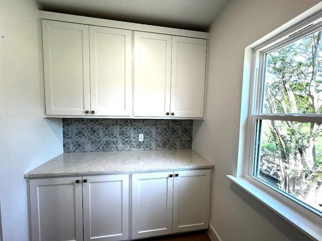 1105 Carroll Ln, La Grange, TX 78945 - kitchen featuring decorative backsplash, white cabinetry, and light stone countertops