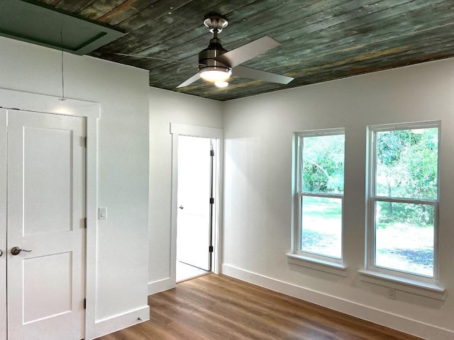 1105 Carroll Ln, La Grange, TX 78945 - unfurnished bedroom with attic access, multiple windows, wood finished floors, wooden ceiling, and ceiling fan