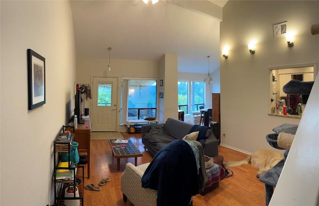 2612 San Pedro St Unit 224, Austin, TX 78705 - living room featuring healthy amount of natural light, wood finished floors, and high vaulted ceiling