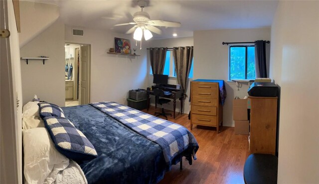 2612 San Pedro St Unit 224, Austin, TX 78705 - bedroom with wood finished floors, ceiling fan, and ensuite bath