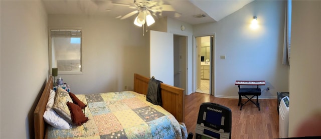 2612 San Pedro St Unit 224, Austin, TX 78705 - bedroom featuring wood finished floors, connected bathroom, and ceiling fan