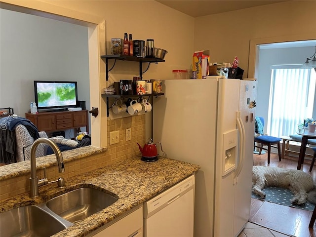 2612 San Pedro St Unit 224, Austin, TX 78705 - kitchen featuring white appliances, backsplash, light stone counters, white cabinets, and light tile patterned floors