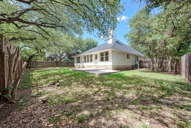 2705 Sabinal Trl, Cedar Park, TX 78613 - back of property with a patio, a fenced backyard, and a chimney