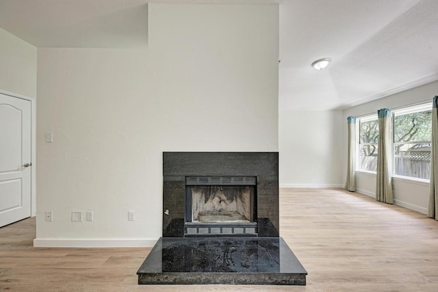 2705 Sabinal Trl, Cedar Park, TX 78613 - unfurnished living room with wood finished floors and a fireplace with raised hearth