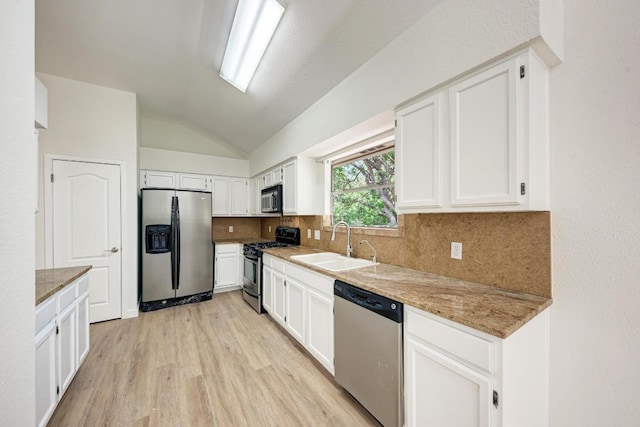 2705 Sabinal Trl, Cedar Park, TX 78613 - kitchen featuring appliances with stainless steel finishes, lofted ceiling, backsplash, light wood-style floors, and white cabinets