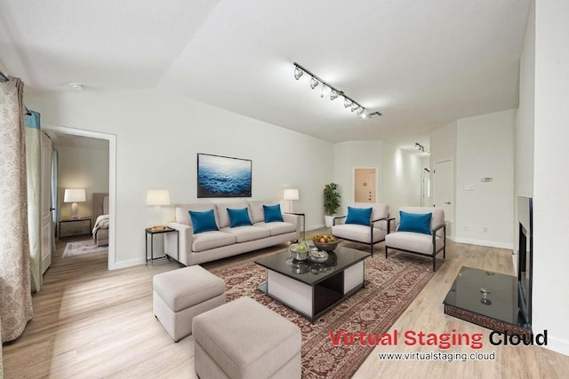 2705 Sabinal Trl, Cedar Park, TX 78613 - living room with wood finished floors, vaulted ceiling, and track lighting