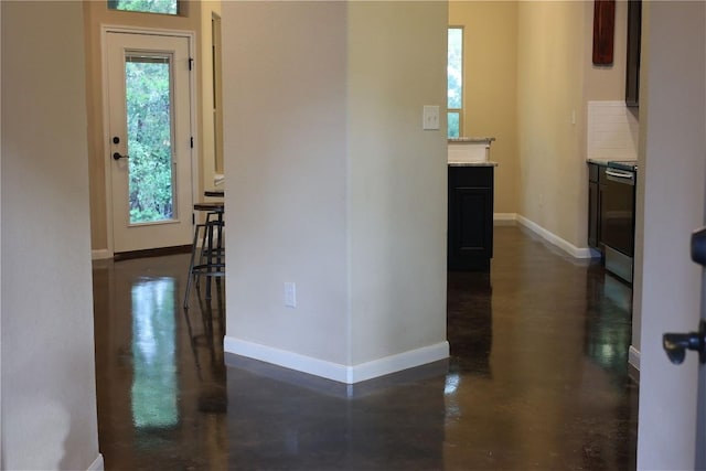 208 Akaloa Dr, Bastrop, TX 78602 - hall featuring baseboards and finished concrete flooring