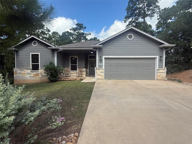 208 Akaloa Dr, Bastrop, TX 78602 - single story home featuring concrete driveway, an attached garage, stone siding, and covered porch