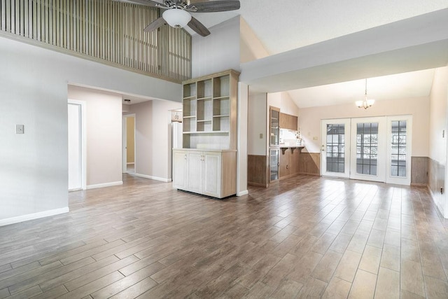 3801 Oak Creek Dr, Austin, TX 78727 - unfurnished living room featuring a ceiling fan, wood finished floors, a chandelier, and high vaulted ceiling