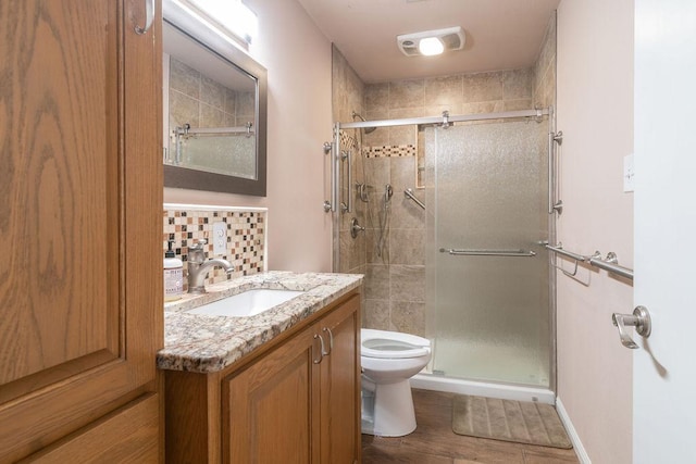 3801 Oak Creek Dr, Austin, TX 78727 - full bathroom featuring a shower stall, vanity, and wood finished floors