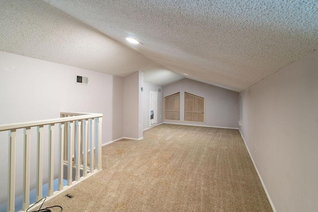 3801 Oak Creek Dr, Austin, TX 78727 - bonus room with carpet floors, vaulted ceiling, and a textured ceiling