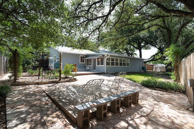 3801 Oak Creek Dr, Austin, TX 78727 - rear view of house featuring a patio, a fenced backyard, a storage shed, and outdoor dining space