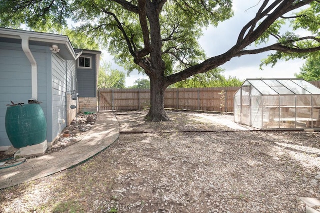 3801 Oak Creek Dr, Austin, TX 78727 - fenced backyard featuring a greenhouse and an outdoor structure