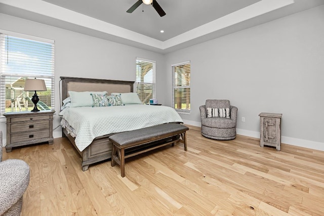 110 Les Ln, Smithville, TX 78957 - bedroom with light wood finished floors, a raised ceiling, a ceiling fan, and recessed lighting