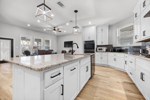 110 Les Ln, Smithville, TX 78957 - kitchen with white microwave, plenty of natural light, tasteful backsplash, and recessed lighting
