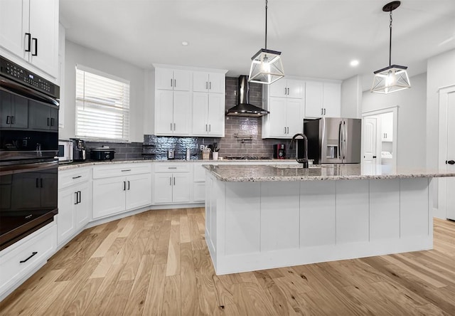 110 Les Ln, Smithville, TX 78957 - kitchen with stainless steel fridge with ice dispenser, wall chimney exhaust hood, light wood-style flooring, decorative backsplash, and recessed lighting